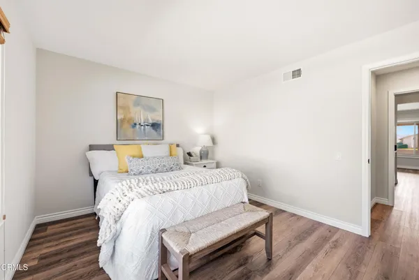a bathroom with a granite countertop sink a mirror and a shower