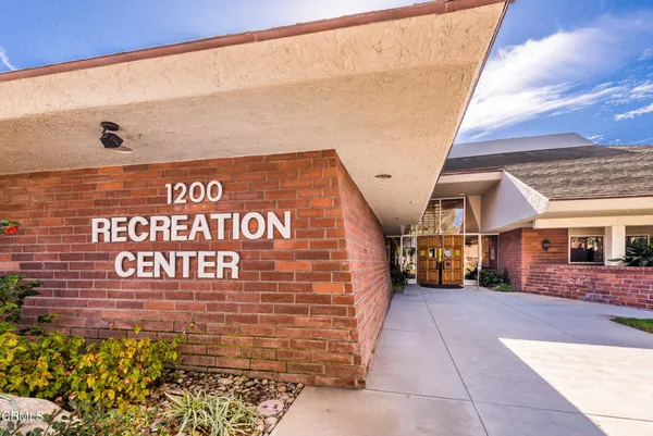 a view of a swimming pool with an outdoor seating and a yard