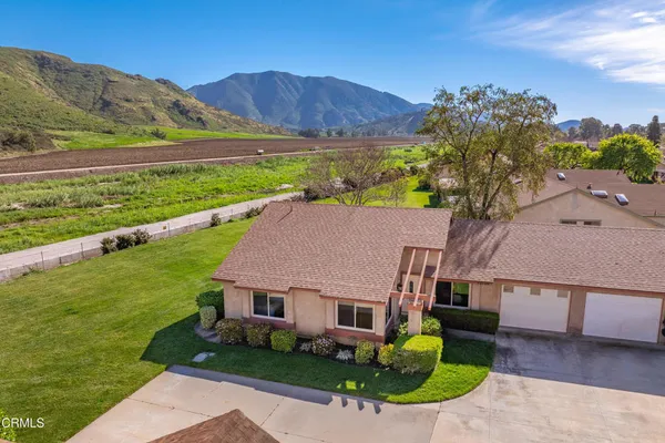 an aerial view of residential houses with outdoor space