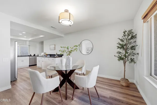 a view of a dining room with furniture and wooden floor