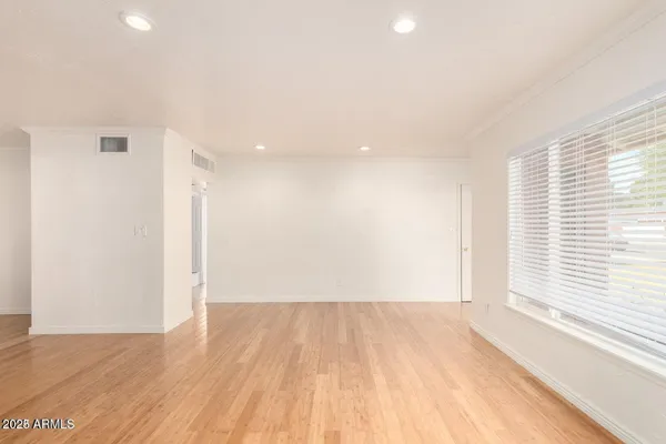 a view of a room with wooden floor and a window