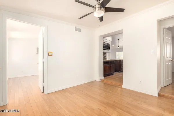 a view of a hallway with wooden floor and closet