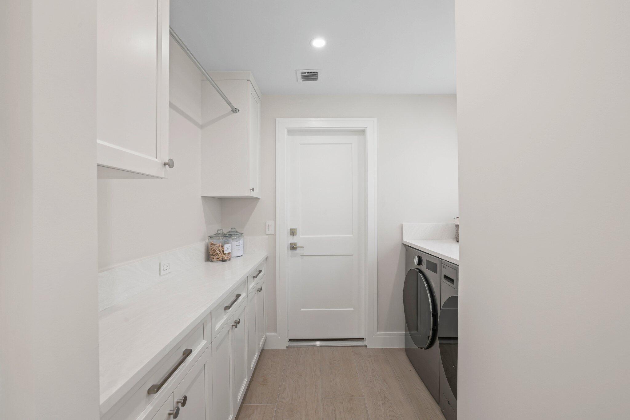 3901 Northwest 27th Avenue Boca Raton, FL 33434 - Photo 27 of 56 a storage room with a washer and dryer