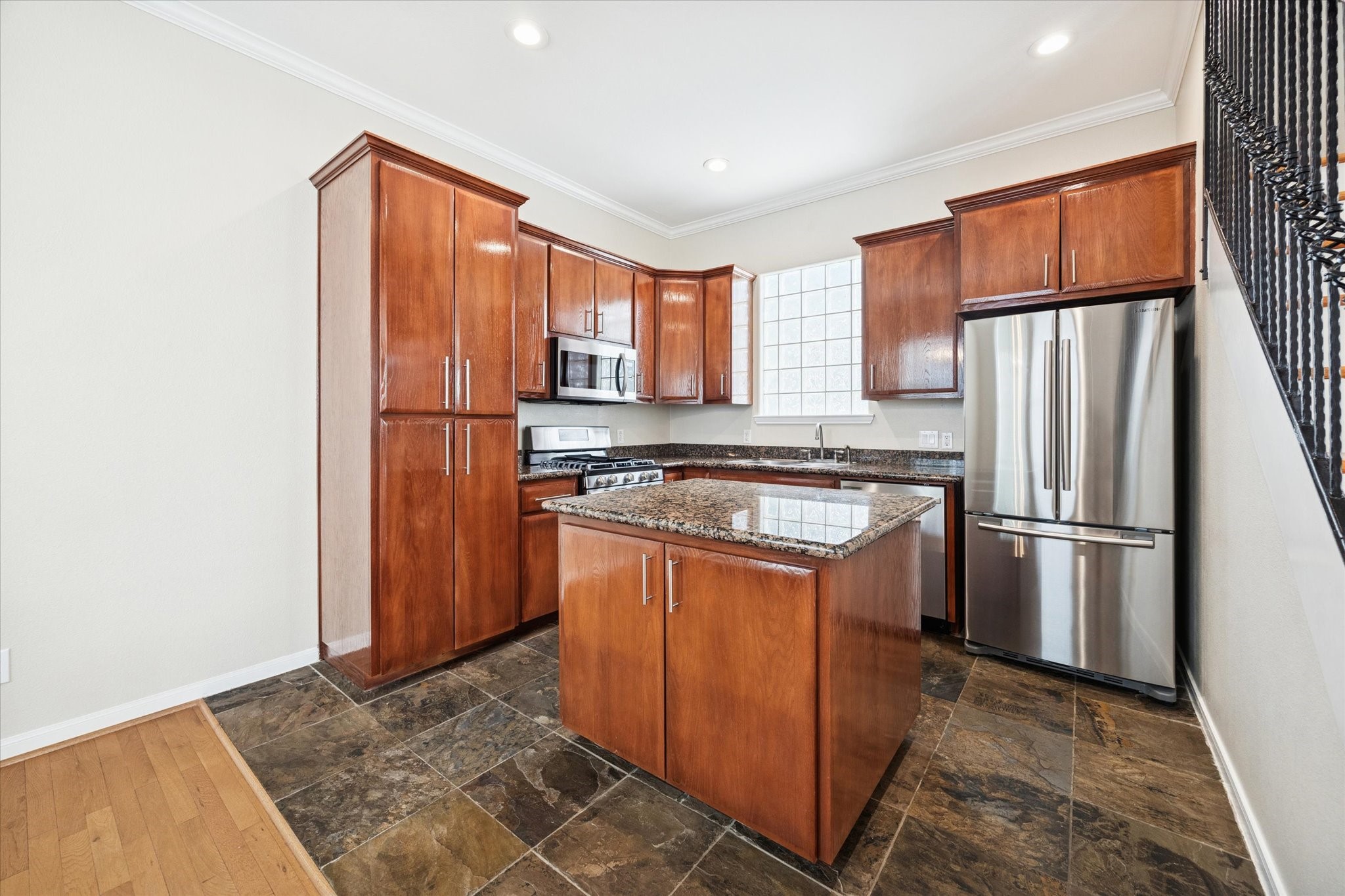1427 West 25th Street Houston, TX 77008 - Photo 12 of 36 a kitchen with stainless steel appliances granite countertop a refrigerator a sink a stove a washer dryer and a refrigerator