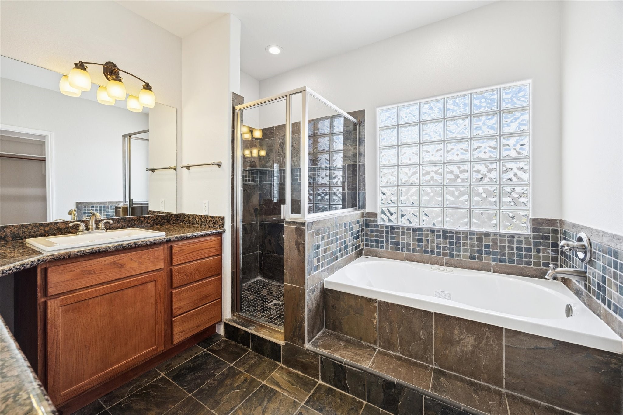 1427 West 25th Street Houston, TX 77008 - Photo 20 of 36 a bathroom with a tub sink shower and a mirror