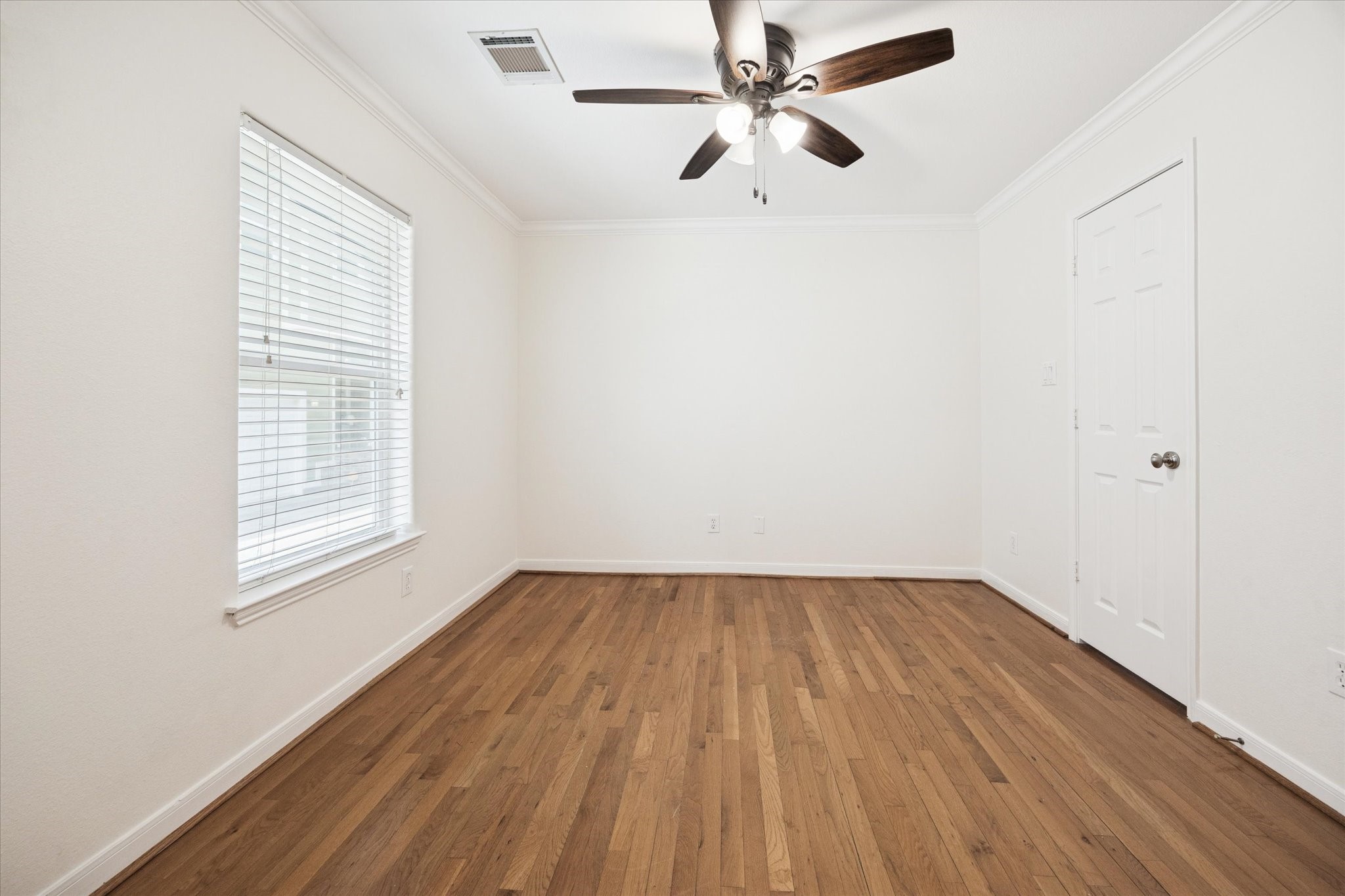 1427 West 25th Street Houston, TX 77008 - Photo 24 of 36 an empty room with wooden floor fan and windows