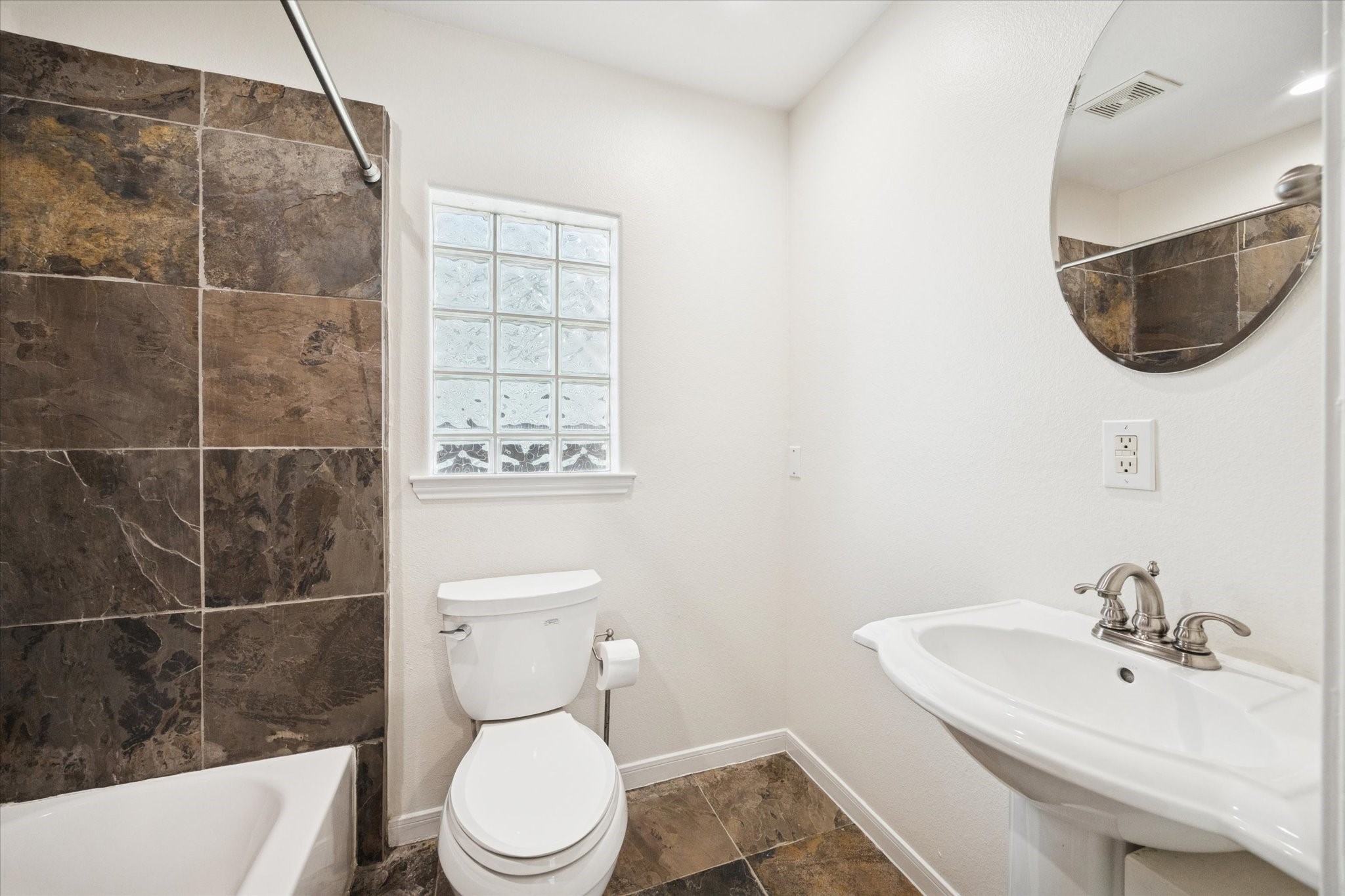 1427 West 25th Street Houston, TX 77008 - Photo 25 of 36 a bathroom with a sink a toilet and mirror