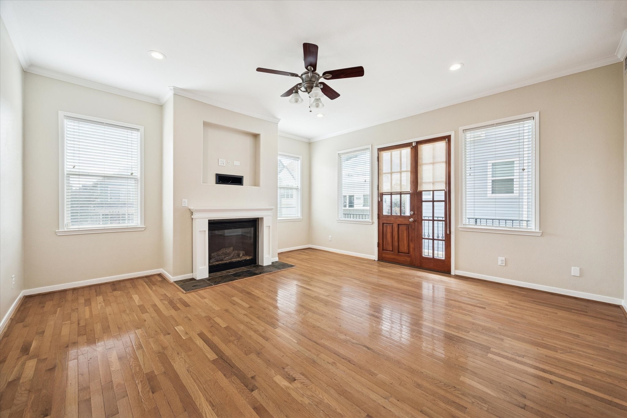 1427 West 25th Street Houston, TX 77008 - Photo 6 of 36 a view of an empty room with wooden floor fireplace and a window