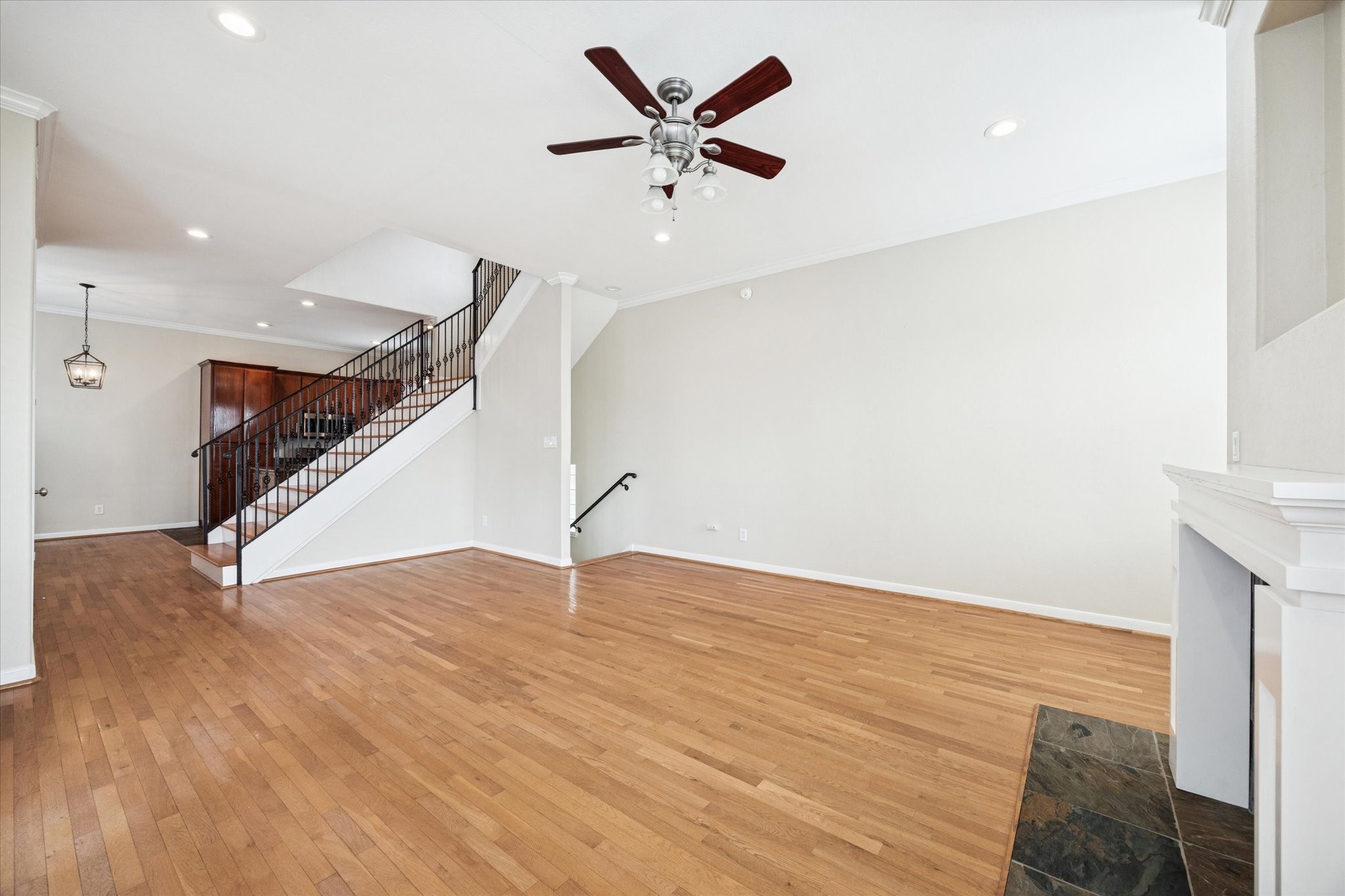 1427 West 25th Street Houston, TX 77008 - Photo 8 of 36 a view of an empty room with wooden floor and a ceiling fan