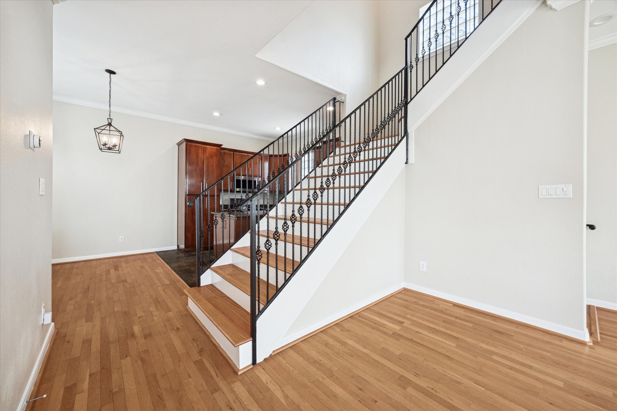 1427 West 25th Street Houston, TX 77008 - Photo 9 of 36 a view of a hallway with wooden floor and stairs