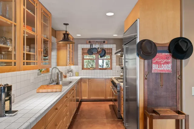 a kitchen with stainless steel appliances a sink a counter space and a window