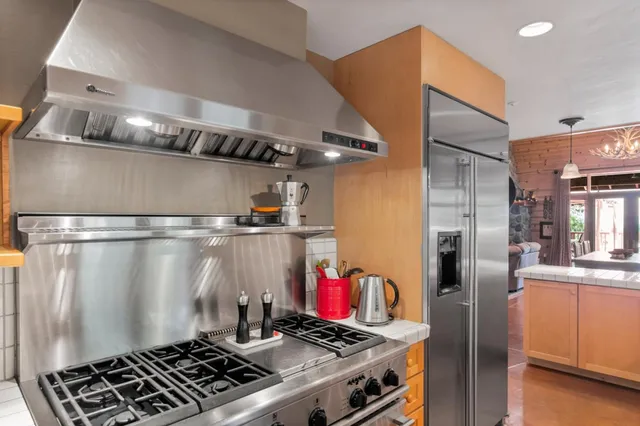 a bathroom with a granite countertop sink mirror double vanity and bathtub