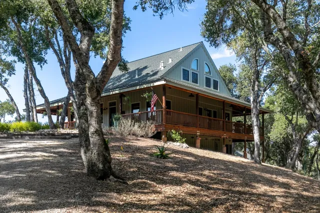 a view of a house with brick walls and flower plants