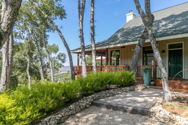 a living room with furniture large window and fireplace