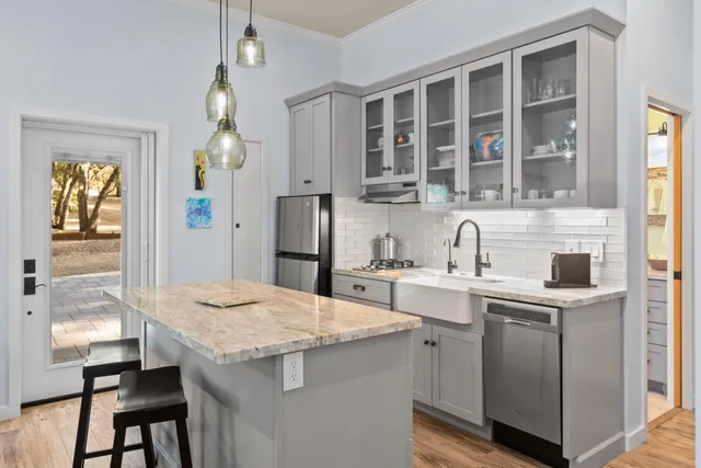 a front view of a house with a tree