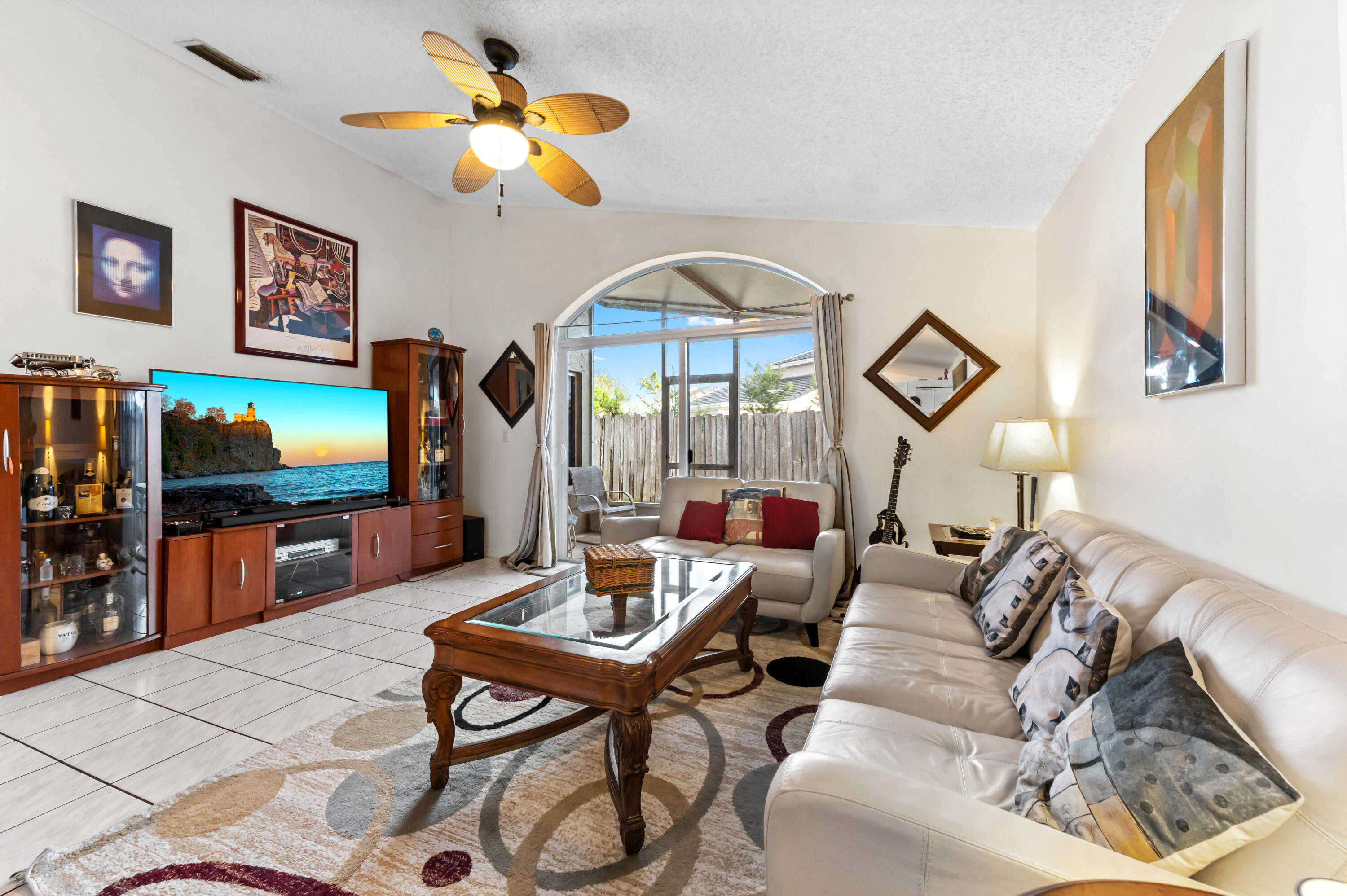 7409 Michigan Isle Road Lake Worth, FL 33467 - Photo 14 of 43 a living room with furniture and a flat screen tv