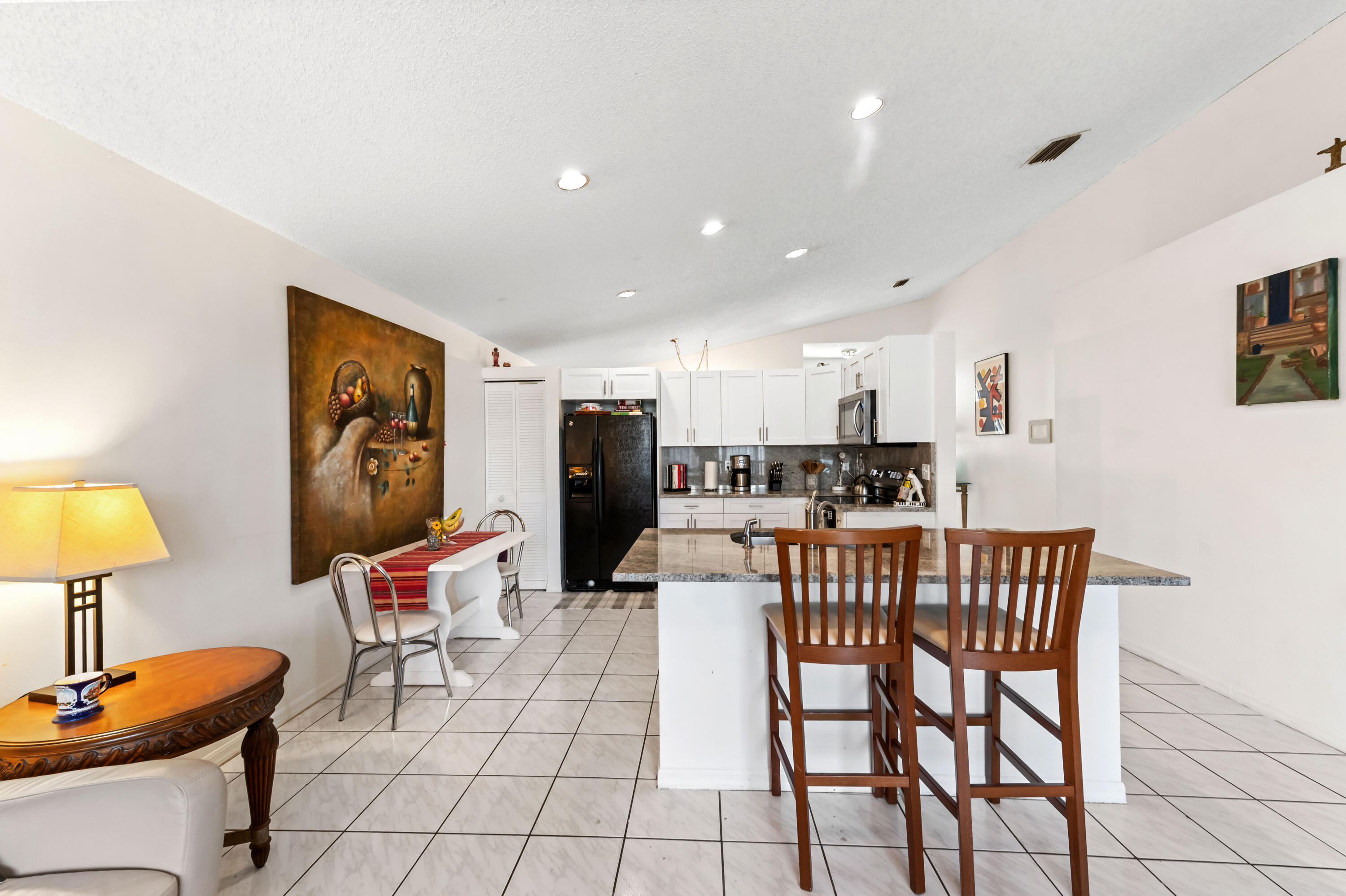 7409 Michigan Isle Road Lake Worth, FL 33467 - Photo 16 of 43 a living room with furniture and a table