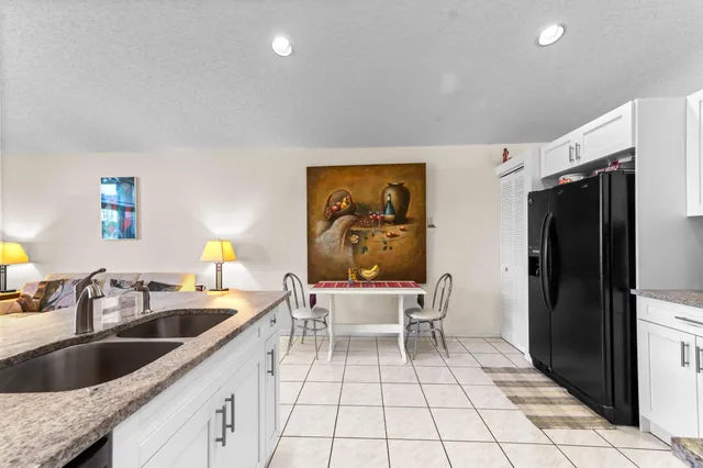a kitchen with a sink cabinets and refrigerator