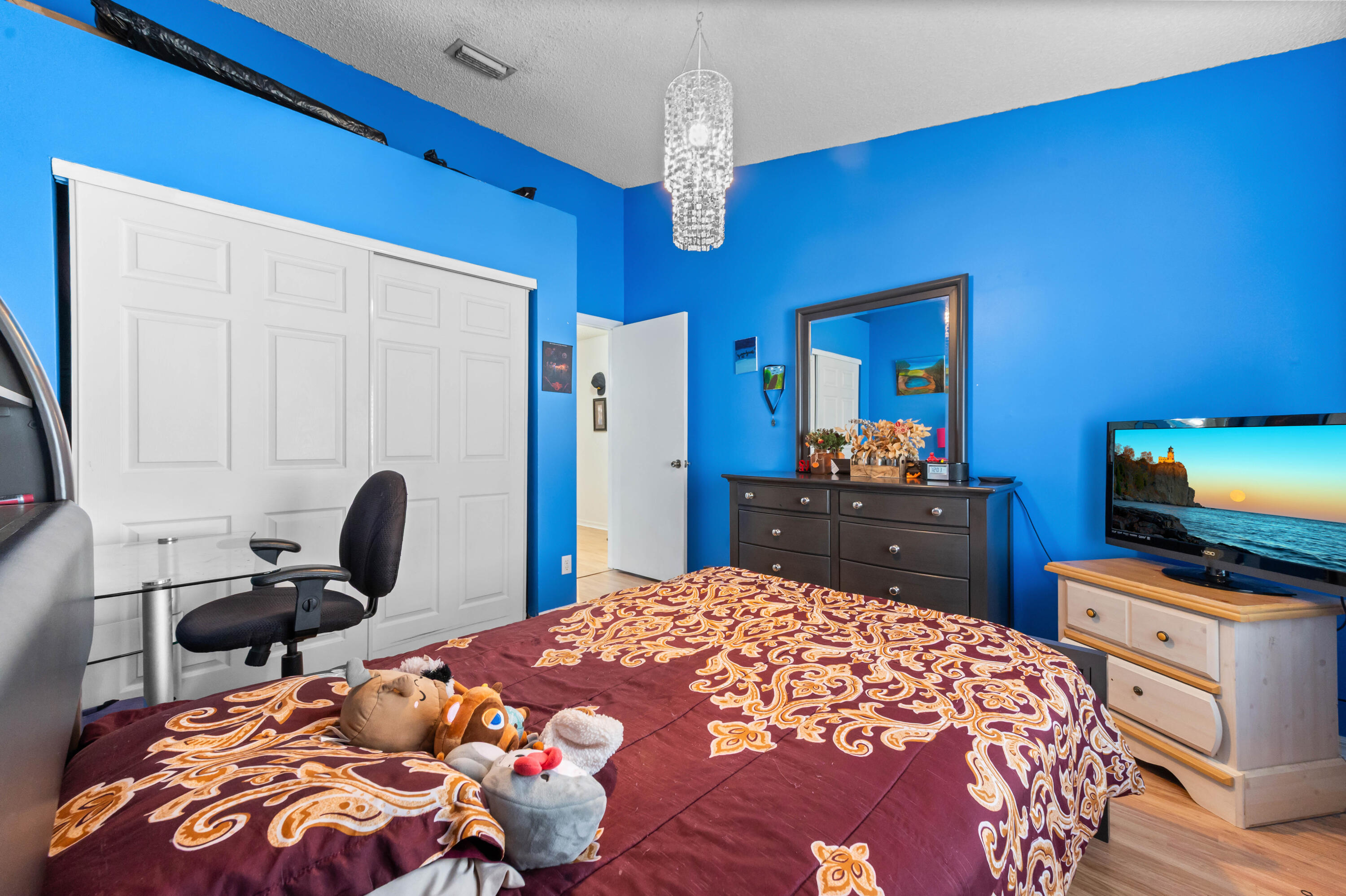 7409 Michigan Isle Road Lake Worth, FL 33467 - Photo 24 of 43 a bedroom with bed and a tv