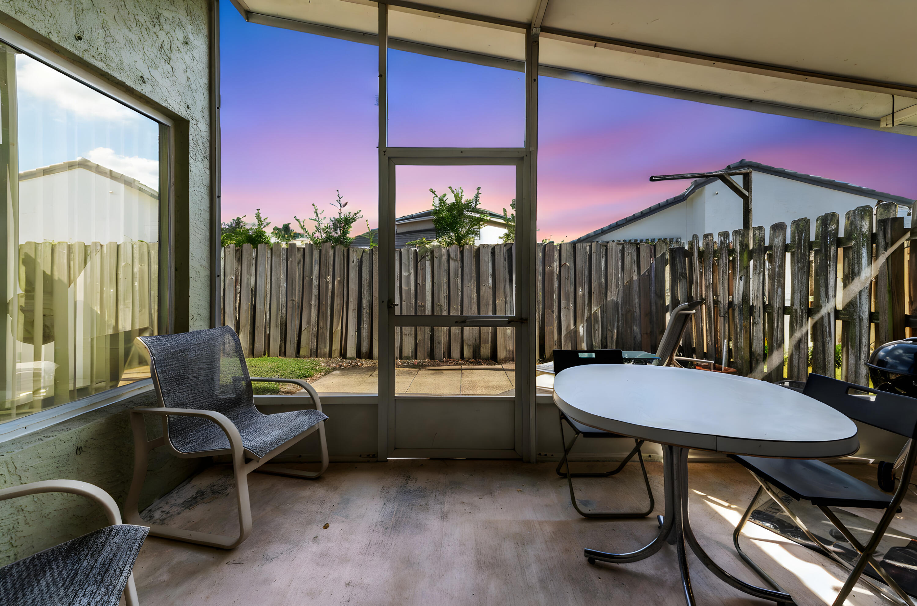 7409 Michigan Isle Road Lake Worth, FL 33467 - Photo 34 of 43 a living room with furniture a rug and a large window