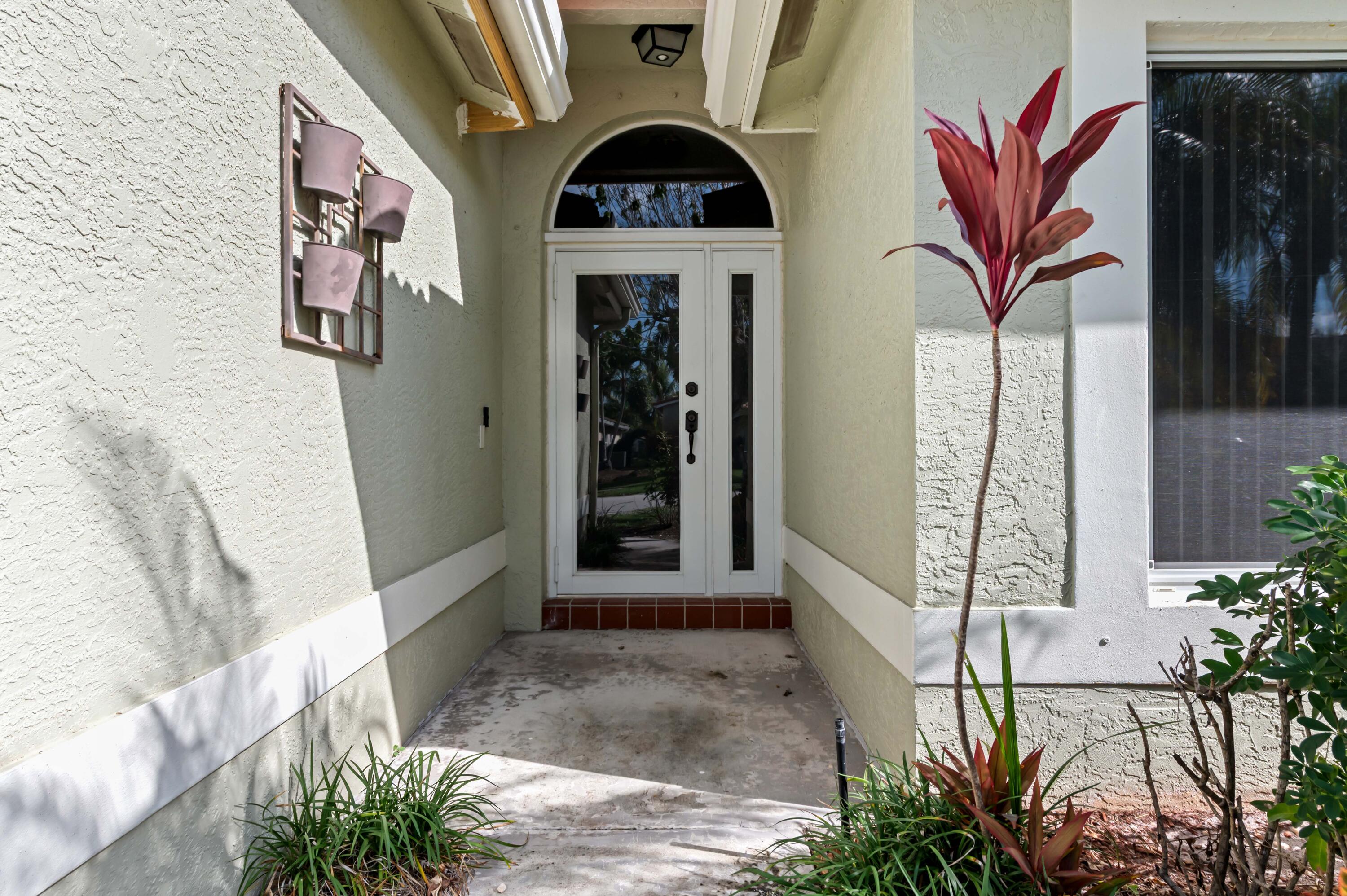 7409 Michigan Isle Road Lake Worth, FL 33467 - Photo 4 of 43 a view of a door with glass door