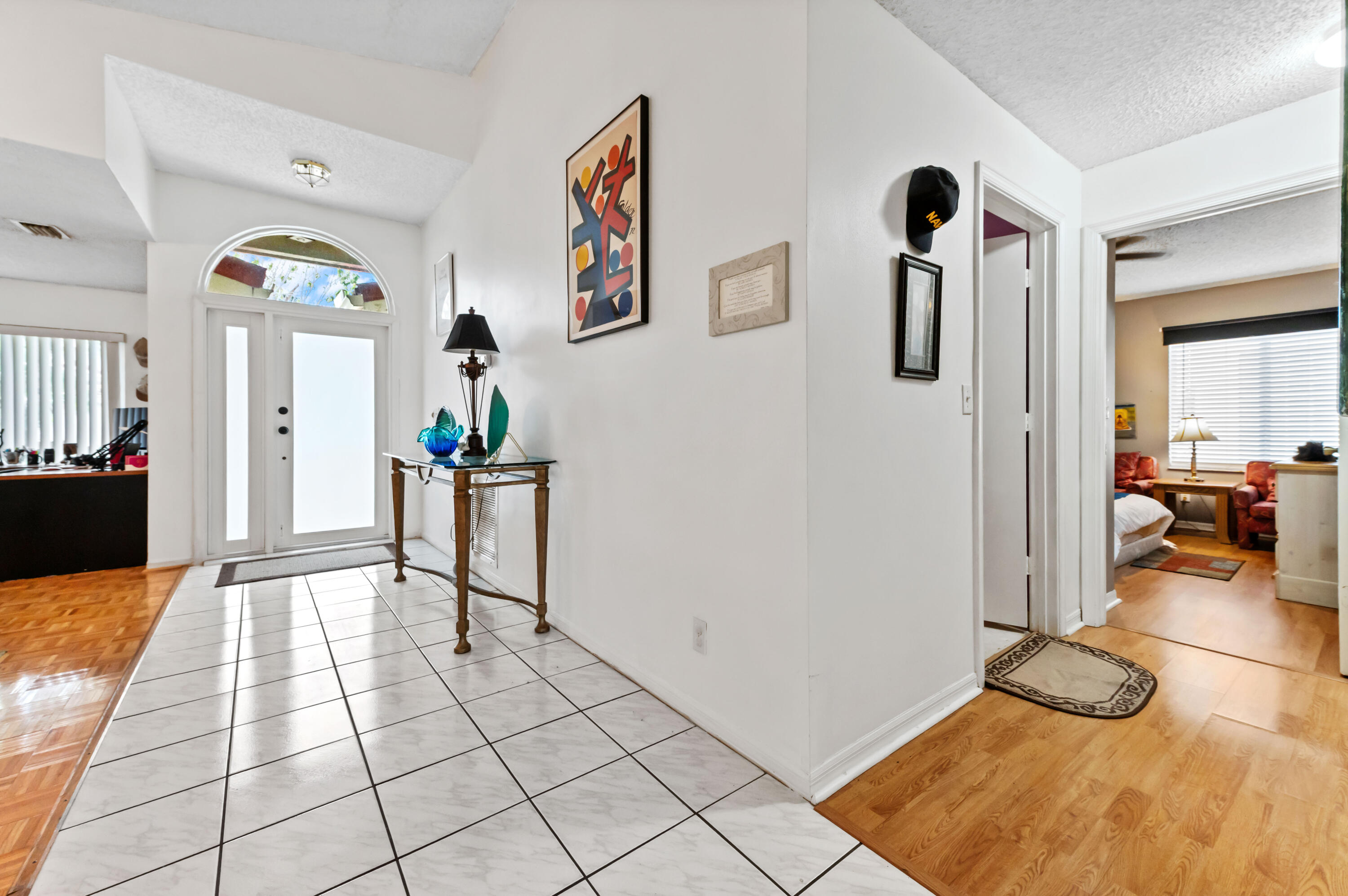 7409 Michigan Isle Road Lake Worth, FL 33467 - Photo 5 of 43 a view of a hallway with wooden floor and furniture