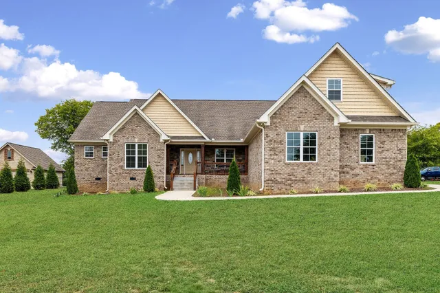 a front view of a house with a yard and garage