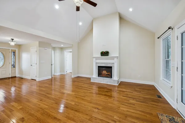 a view of a room with wooden floor