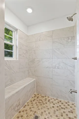 a bathroom with a bathtub and shower