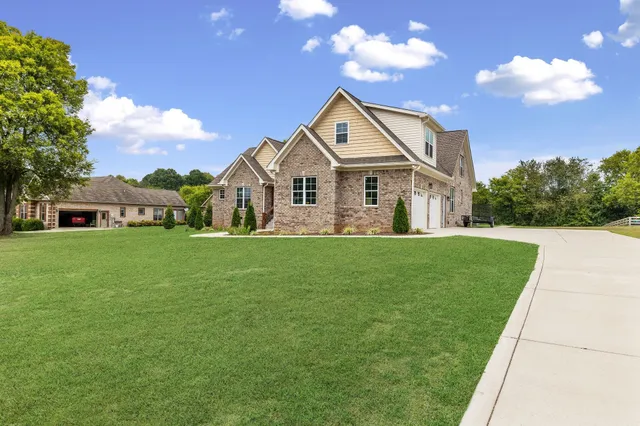 a front view of house with yard and green space