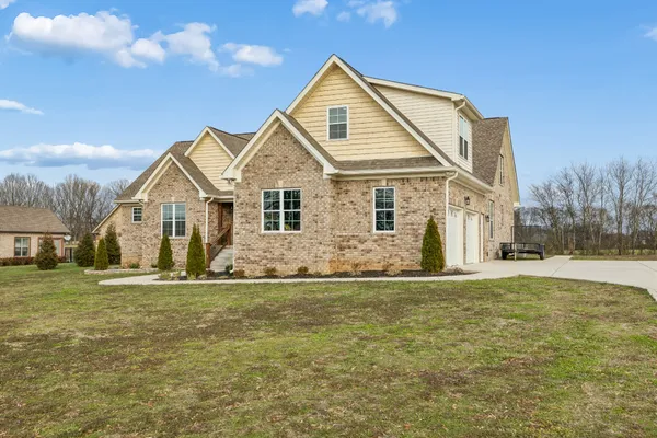 a view of kitchen and empty room with wooden floor
