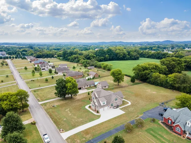an aerial view of a house with garden space and ocean view