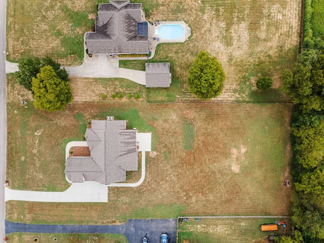 an aerial view of a house with swimming pool