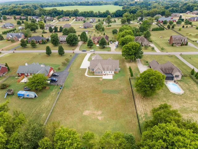 an aerial view of a residential houses with outdoor space