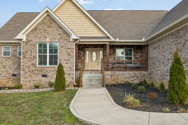 a view of an empty room with window and fire place