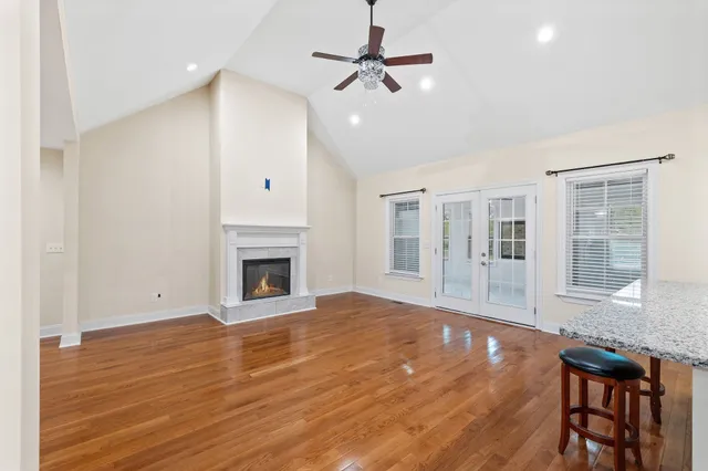 a view of an empty room with a window and fireplace