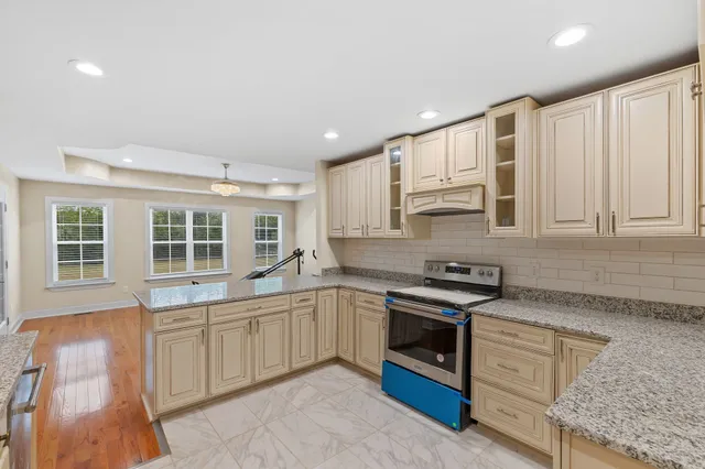a kitchen with stainless steel appliances granite countertop a stove and a sink