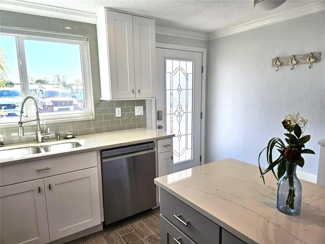 a kitchen with a sink and cabinets