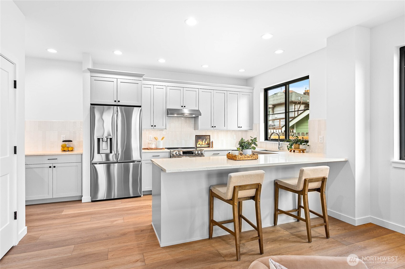 105 South 8th Street, Unit 102 Lynden, WA 98264 - Photo 6 of 9 a kitchen with white cabinets and stainless steel appliances