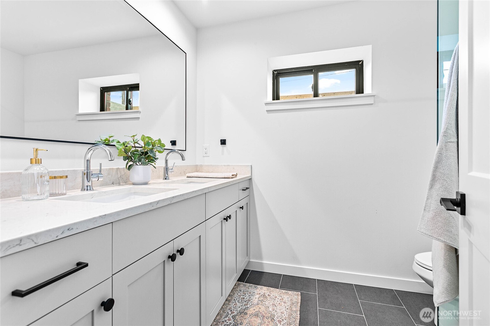 105 South 8th Street, Unit 102 Lynden, WA 98264 - Photo 9 of 9 a bathroom with a sink a toilet and mirror