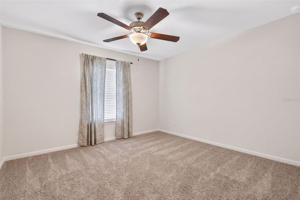2429 Twin Lake View Road Winter Haven, FL 33881 - Photo 36 of 37 an empty room with a ceiling fan and window
