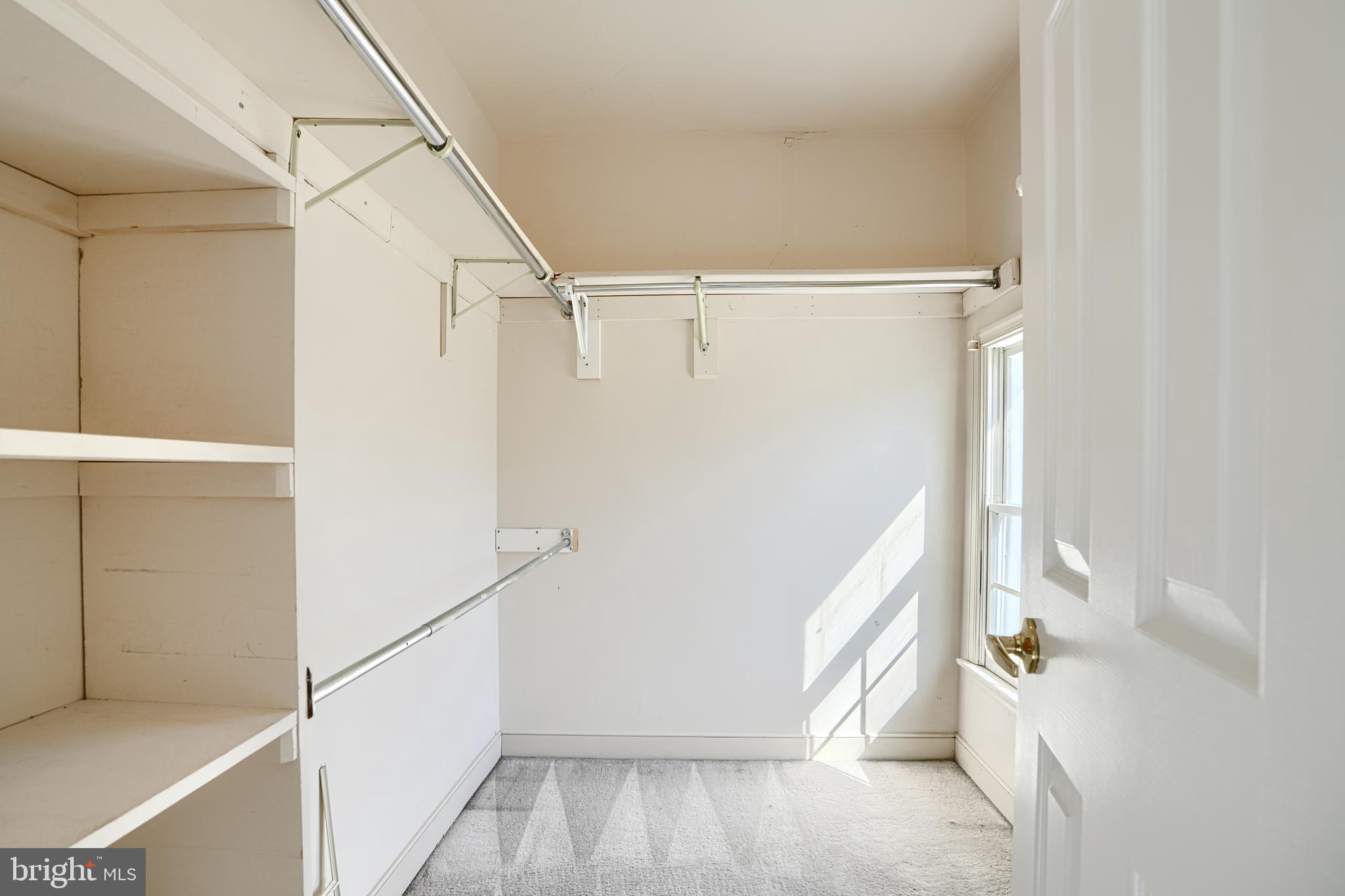 9018 Gardenia Road Baltimore, MD 21236 - Photo 22 of 47 a view of walk in closet with empty racks