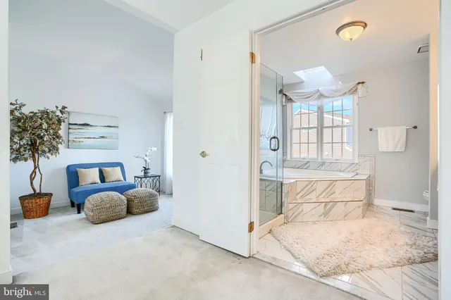 a bedroom with furniture and a chandelier