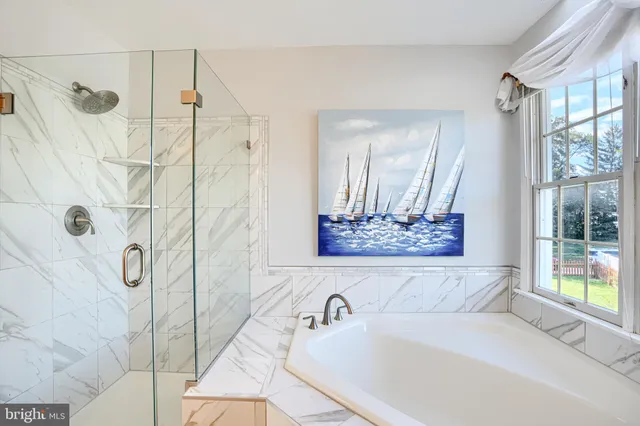 a bathroom with a tub and a shower