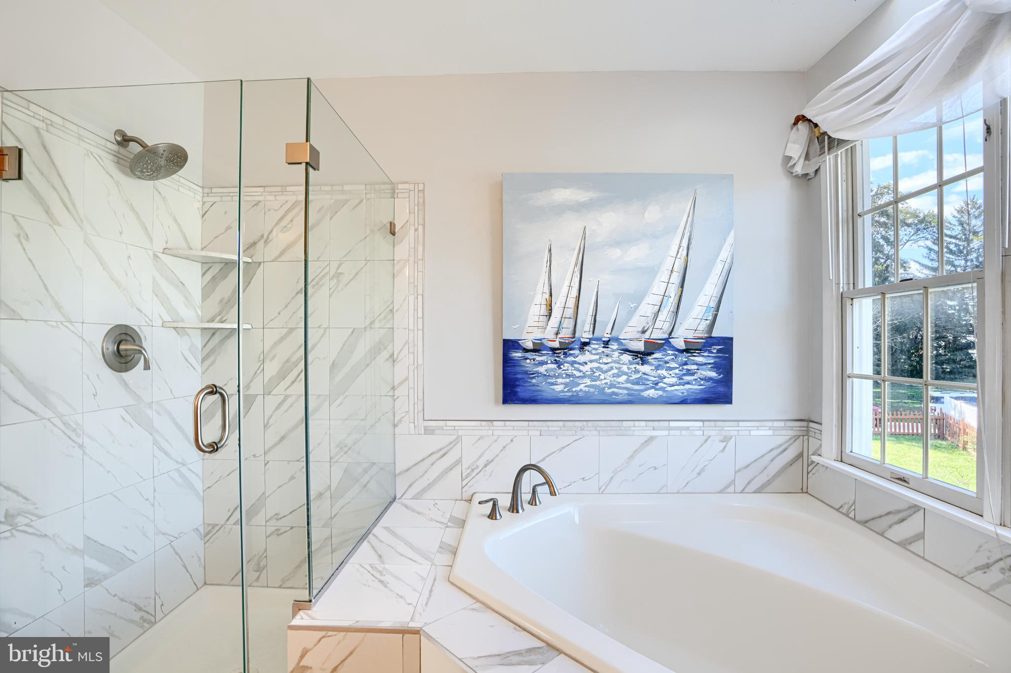 9018 Gardenia Road Baltimore, MD 21236 - Photo 27 of 47 a bathroom with a tub and a shower