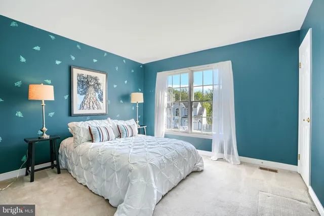 a bedroom with a bed and a lamp