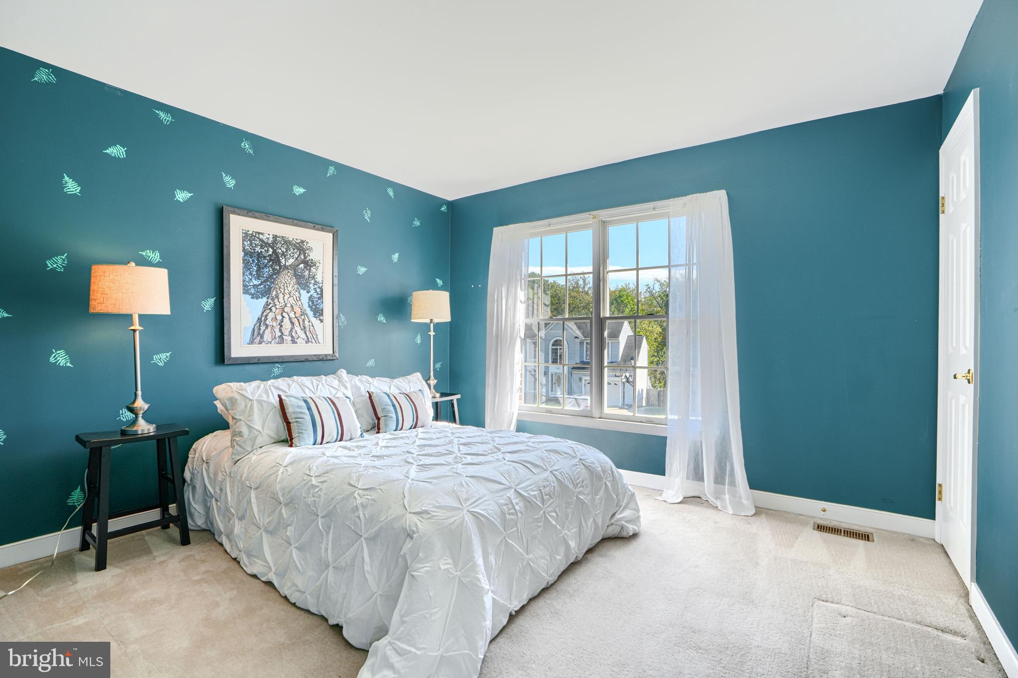 9018 Gardenia Road Baltimore, MD 21236 - Photo 29 of 47 a bedroom with a bed and a lamp