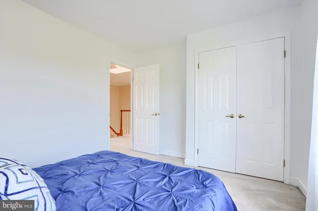 a bedroom with a bed and a mirror