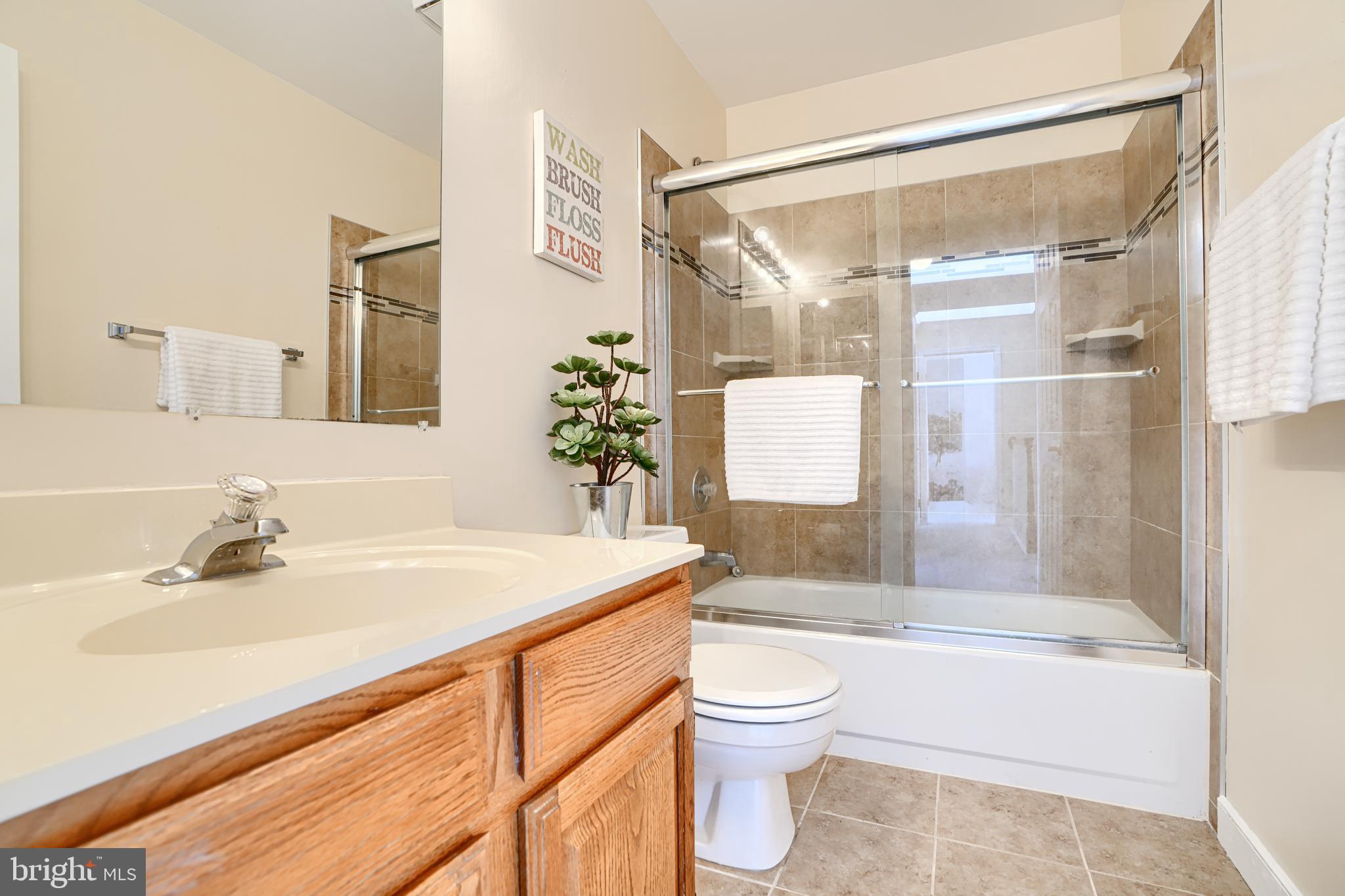 9018 Gardenia Road Baltimore, MD 21236 - Photo 33 of 47 a bathroom with a sink toilet and shower