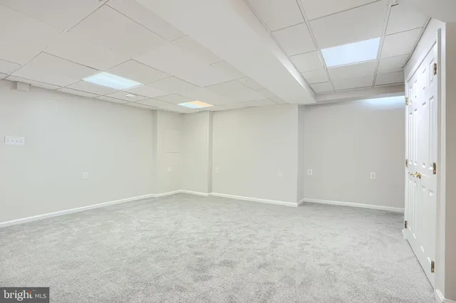 a bedroom with a bed and painting on the wall